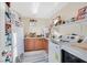 Laundry room with modern washer and dryer, storage shelves, and tile floor at 2194 Trivero St, Henderson, NV 89044