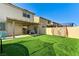 This spacious backyard featuring artificial grass, covered patio, and entertainment area at 2531 Dollison Ave, North Las Vegas, NV 89081