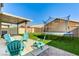 A Gathering friendly backyard with artificial grass, patio furniture, and a fun trampoline at 2531 Dollison Ave, North Las Vegas, NV 89081