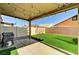 This outdoor space features artificial grass, an outdoor kitchen and a covered patio at 2531 Dollison Ave, North Las Vegas, NV 89081