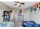 Shared room featuring two beds, playful wall decor, and an organized shelving unit at 2531 Dollison Ave, North Las Vegas, NV 89081