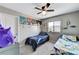 bedroom featuring colorful decor, including posters, dinosaur decals, and two twin beds at 2531 Dollison Ave, North Las Vegas, NV 89081