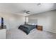 Neutral carpeted bedroom with bright light, fan, and dresser at 2531 Dollison Ave, North Las Vegas, NV 89081