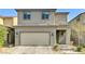 Charming two-story home features a neutral color scheme, attached garage, and well-manicured landscaping at 2531 Dollison Ave, North Las Vegas, NV 89081
