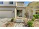 A quaint two-story home with a two-car garage, stone-paved walkway, and manicured landscaping at 2531 Dollison Ave, North Las Vegas, NV 89081