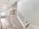 Hallway with light wood floors leading to carpeted stairs with white railing at 2531 Dollison Ave, North Las Vegas, NV 89081