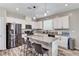 Bright kitchen features white cabinets, stainless steel appliances, and island with barstool seating at 2531 Dollison Ave, North Las Vegas, NV 89081