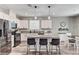Well-lit kitchen features stainless appliances, granite counters, and barstool seating at island at 2531 Dollison Ave, North Las Vegas, NV 89081