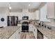 Well-equipped kitchen featuring stainless appliances, granite counters, and ample cabinet space at 2531 Dollison Ave, North Las Vegas, NV 89081