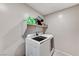 Laundry room featuring modern washer and dryer units with overhead shelving for convenient storage at 2531 Dollison Ave, North Las Vegas, NV 89081