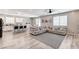 Spacious open-concept living area with a large gray sectional and modern flooring at 2531 Dollison Ave, North Las Vegas, NV 89081
