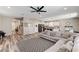 Spacious living area with a large sectional couch and seamless kitchen access at 2531 Dollison Ave, North Las Vegas, NV 89081
