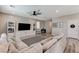 Comfortable living room with gray couch, entertainment center, and access to other areas at 2531 Dollison Ave, North Las Vegas, NV 89081