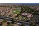 Aerial view featuring the community center alongside a beautiful golf course, lush trees and desert homes at 2624 Spalding Dr, Las Vegas, NV 89134