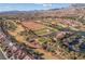 Expansive aerial view of the community with the golf course, water, and mountain views at 2624 Spalding Dr, Las Vegas, NV 89134