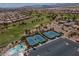 Expansive aerial view of golf course with multiple tennis courts, a parking lot, and beautiful residential homes at 2624 Spalding Dr, Las Vegas, NV 89134
