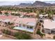 Aerial view of a desert home with terra cotta roof, back patio, and mountain views at 2624 Spalding Dr, Las Vegas, NV 89134