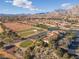 Stunning aerial view of golf course, community, and water feature, showcasing a vibrant lifestyle at 2624 Spalding Dr, Las Vegas, NV 89134