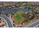 A stunning aerial view showcases baseball field, tennis courts, pool, clubhouse, parking lot and lush landscaping at 2624 Spalding Dr, Las Vegas, NV 89134