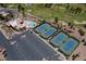 A stunning aerial view showcases tennis courts, pool, clubhouse, parking lot, and a meticulously maintained golf course at 2624 Spalding Dr, Las Vegas, NV 89134
