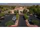 Aerial view of community center; lush trees surround parking in a desert community with mountains as backdrop at 2624 Spalding Dr, Las Vegas, NV 89134