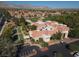 Aerial view showcasing bocce ball courts and the community center, set amidst lush trees and a golf course at 2624 Spalding Dr, Las Vegas, NV 89134
