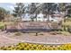 The Pinnacle Community Center sign surrounded by flowers and greenery, offering dining and entertainment at the golf course at 2624 Spalding Dr, Las Vegas, NV 89134