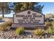 The Highland Falls Golf Club sign open to the public with desert landscaping and mature trees on a sunny day at 2624 Spalding Dr, Las Vegas, NV 89134