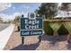 An Eagle Crest golf course sign surrounded by plants, rock landscaping, and blue sky with green trees in the background at 2624 Spalding Dr, Las Vegas, NV 89134