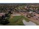 Aerial view showcasing a lush green golf course surrounded by lovely desert homes and community streets at 2624 Spalding Dr, Las Vegas, NV 89134
