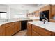 Spacious kitchen showcasing oak cabinets, stainless steel appliances, and a large island with white countertops and a sink at 2624 Spalding Dr, Las Vegas, NV 89134