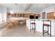 Bright, open kitchen area with wooden cabinets, modern black appliances and a large island with bar stool seating at 2624 Spalding Dr, Las Vegas, NV 89134
