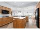 Spacious eat-in kitchen with wooden cabinets, stainless steel appliances, and a bright breakfast nook with backyard views at 2624 Spalding Dr, Las Vegas, NV 89134
