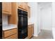 Gourmet kitchen with oak cabinets and modern appliances, including a built-in double oven for culinary enthusiasts at 2624 Spalding Dr, Las Vegas, NV 89134