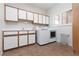 Functional laundry room featuring modern washer and dryer, ample counter space, and custom cabinets for organized storage at 2624 Spalding Dr, Las Vegas, NV 89134