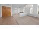 Spacious living room with tile and carpet floors, large windows, and a chandelier at 2624 Spalding Dr, Las Vegas, NV 89134