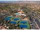 Aerial view of the tennis courts, community pool, clubhouse, and mountain views at 2624 Spalding Dr, Las Vegas, NV 89134