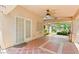 Covered patio area with ceiling fan and door to the house at 2707 Wild Breeze Ct, North Las Vegas, NV 89031