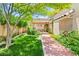 Lush backyard featuring a covered patio, well-manicured lawn, and beautiful landscaping at 2707 Wild Breeze Ct, North Las Vegas, NV 89031