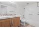 Bright bathroom with a wooden vanity, tile backsplash and tile flooring at 2707 Wild Breeze Ct, North Las Vegas, NV 89031