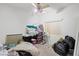 Cluttered bedroom with window and fan; needs decluttering at 2707 Wild Breeze Ct, North Las Vegas, NV 89031