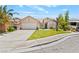 Charming single-story home featuring a tidy lawn and a double-wide driveway leading to a two-car garage at 2707 Wild Breeze Ct, North Las Vegas, NV 89031