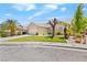 Well-maintained single-story home with green lawn, desert landscaping and spacious driveway at 2707 Wild Breeze Ct, North Las Vegas, NV 89031