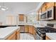 Bright kitchen with stainless steel appliances and tile countertops at 2707 Wild Breeze Ct, North Las Vegas, NV 89031
