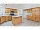 Open kitchen with center island, stainless appliances, and tiled flooring at 2707 Wild Breeze Ct, North Las Vegas, NV 89031