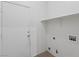 Functional laundry room with utility hookups and a built-in shelf at 2707 Wild Breeze Ct, North Las Vegas, NV 89031