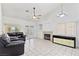 Cozy living room with a fireplace, tile flooring, and a ceiling fan at 2707 Wild Breeze Ct, North Las Vegas, NV 89031