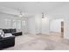 Bright and open living room featuring tile flooring, vaulted ceilings, and large windows that bring in ample natural light at 2707 Wild Breeze Ct, North Las Vegas, NV 89031