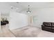 Bright living room with carpet, ceiling fan and adjacent seating areas at 2707 Wild Breeze Ct, North Las Vegas, NV 89031