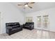 Living room with tile flooring, a ceiling fan, and access to the backyard at 2707 Wild Breeze Ct, North Las Vegas, NV 89031